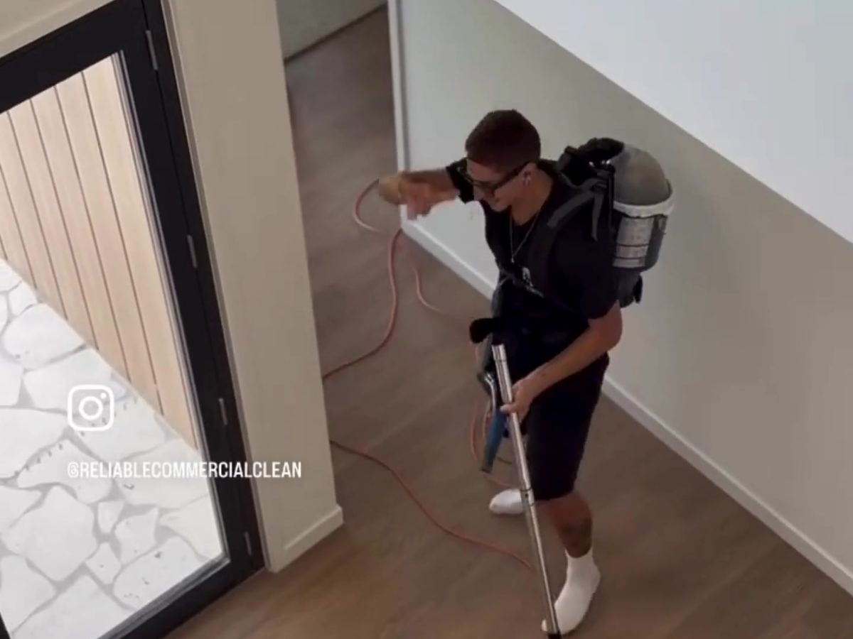 Cleaner vacuuming the floors of a new build home during a builders clean on the Sunshine Coast